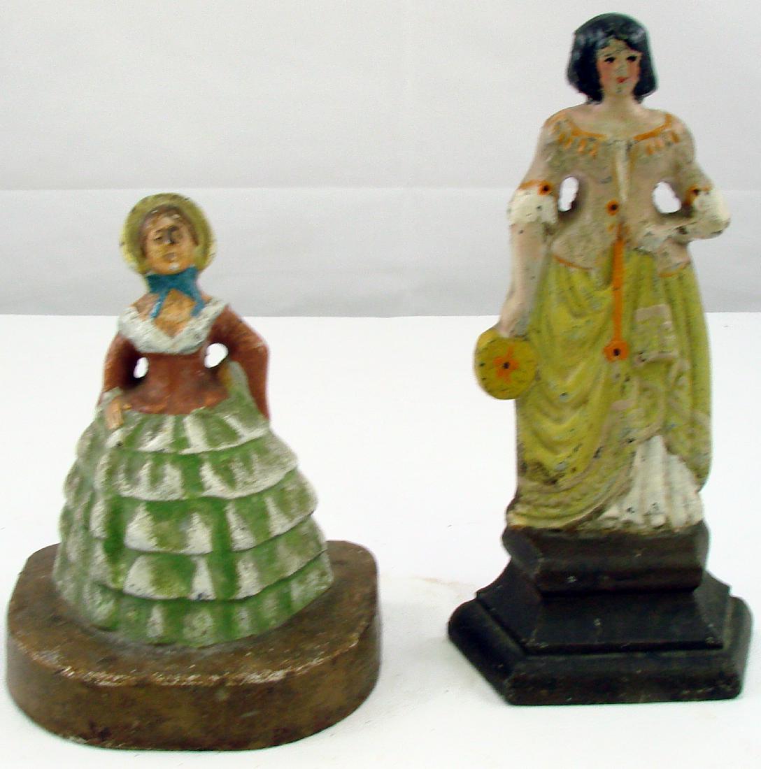 (2) LADY DOORSTOPS: Painted cast iron; (1) Albany Lady on pedestal - very minor paint loss; (1) C.J.O. Judd - Southern Lady Belle, dress bonnet; minor paint loss, some edges are worn; tallest H-7 1/2", G-VG