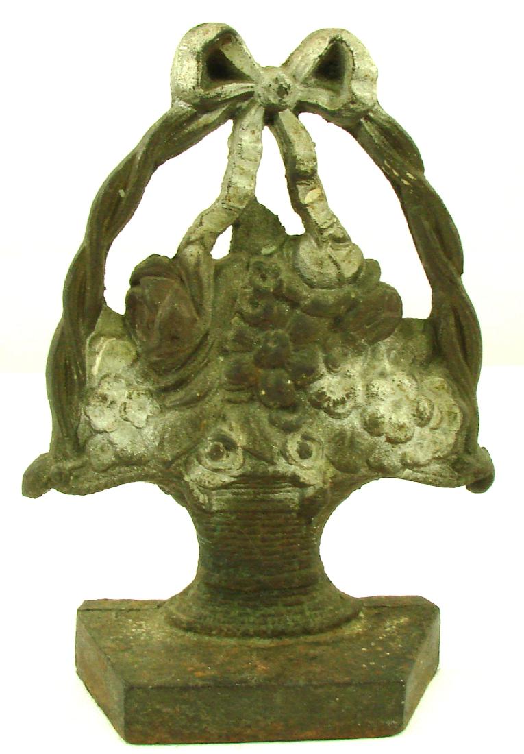 BASKET OF FLOWERS CAST IRON DOORSTOP: Arthur Mfg Co., Baltimore Maryland; mostly unpainted with traces of silver and red paint; H-8 1/2", G