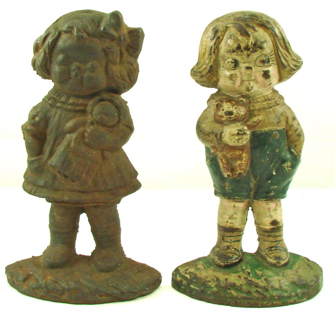 BOBBY BLAKE & DOLLY DIMPLE DOORSTOPS: Cast iron; (1) Bobby Blake: moderate paint loss and wear; paint appears original; (1) Dolly Dimple: no paint, moderate surface rust; H-9 1/4", F-G