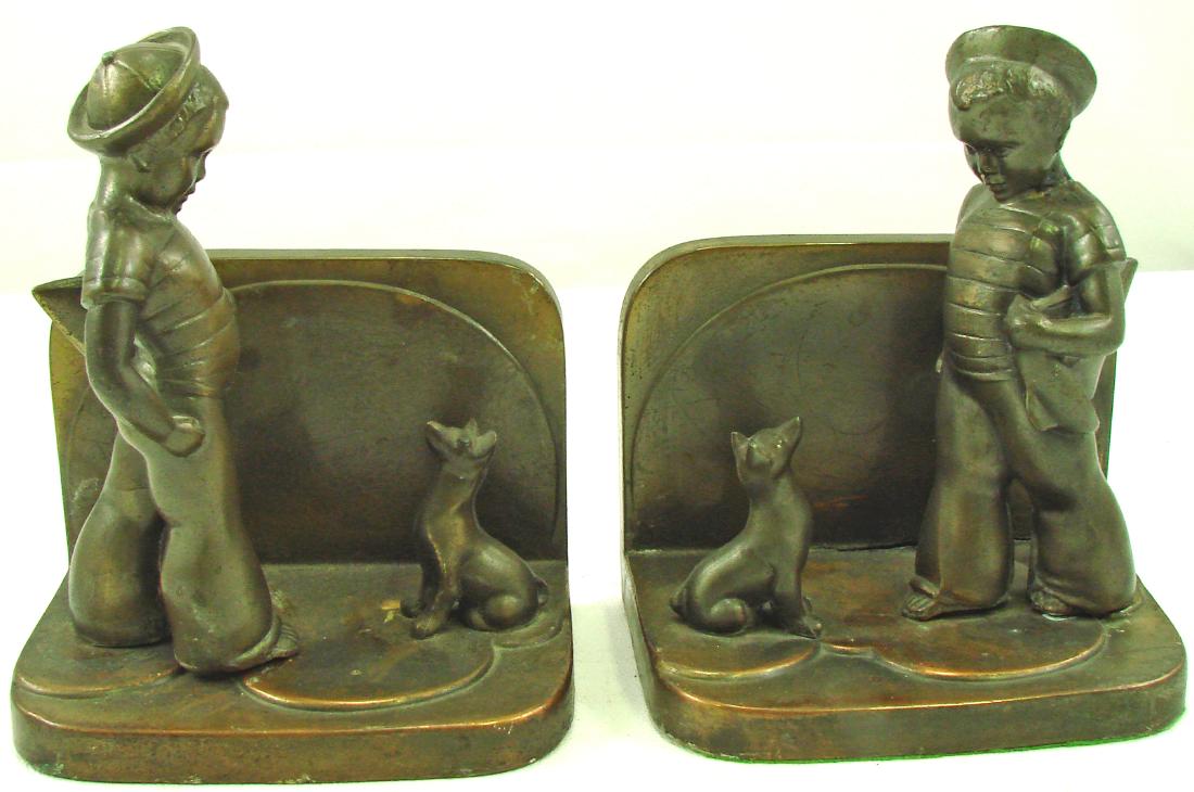 PAIR FRANKART ART DECO SAILOR BOY BOOKENDS: Patinated metal; boy in sailor's hat with his dog; stress crack to seam on one; figure loose on one; H-6 1/2", L-5 1/2", G+