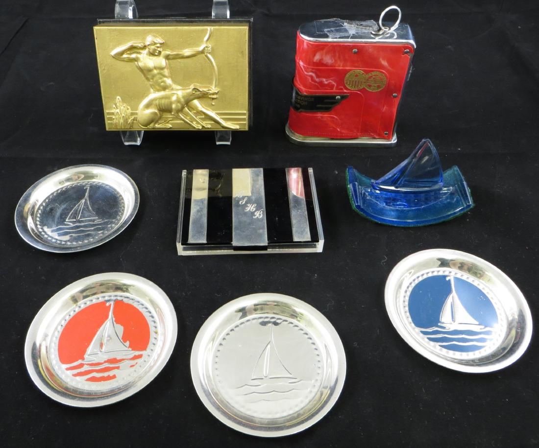 (8) DECO TABLE / DESK ACCESSORIES: (4) metal and enameled sailboat coasters, (1) blue glass sailboat blotter, (1) engraved plexiglas and metal cigarette box, (1) Hickok relief card box; cardbox has chip on interior rim; blotter has rep