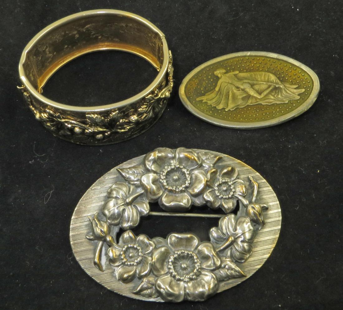 (3) PIECES VINTAGE COSTUME JEWELRY: EARLY CORO ETC: Includes: (1) silvertone brooch, with ring of flowers, signed Harmon's, C-clasp, L-3 1/4"; (1) oval brooch featuring nude laying across a divan (face down), embossed, covered with enamel, signed illeg