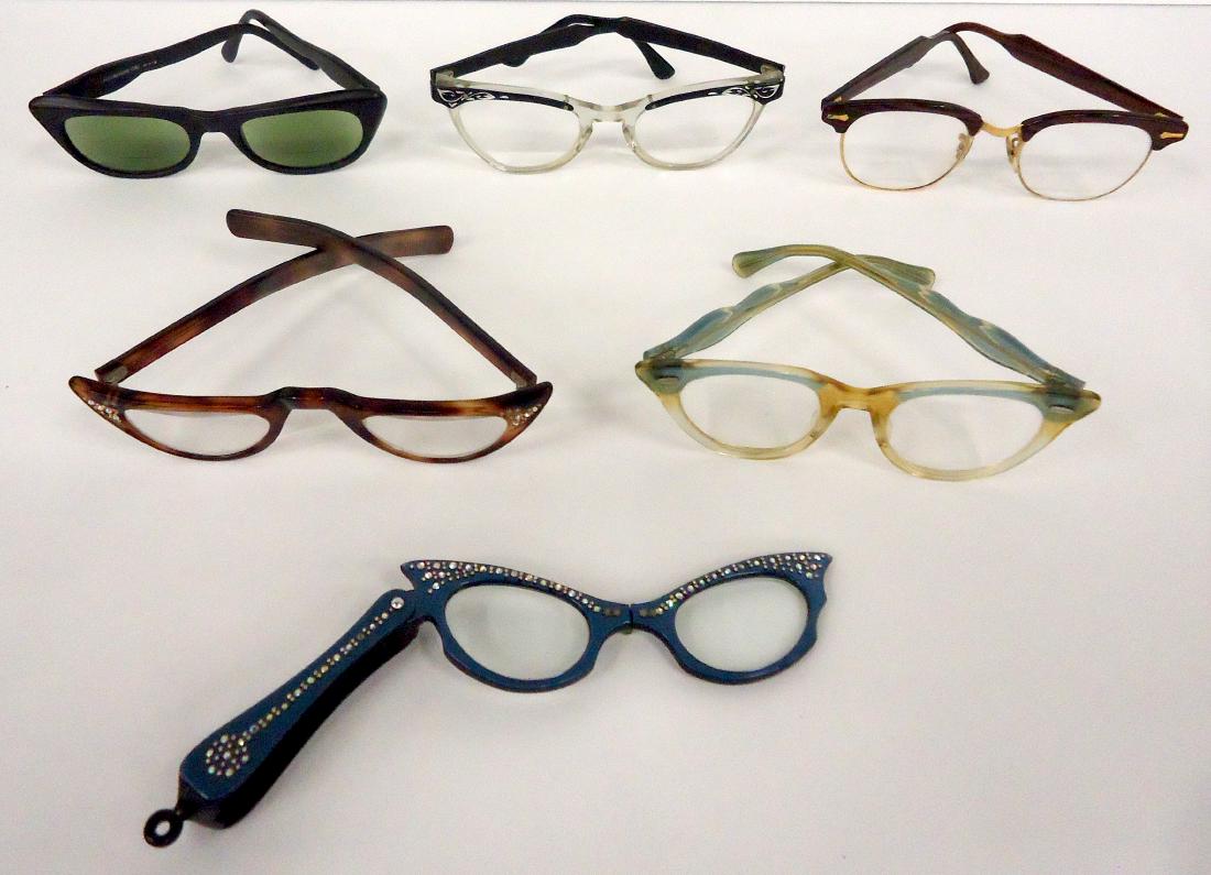 (6) PAIRS VINTAGE EYEGLASSES: (1) Horn rim, USA, SIZE 5 1/2, rubbing; (1) blue lorgniette with rhinestones; (1) clear and black metal, size 5 1/2"; (1) black sunglasses, Christian frame, Italy #618, size 5 1/2"; (1) clear and ligh