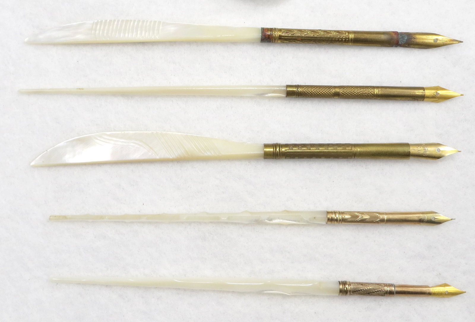 (5) VINTAGE MOTHER OF PEARL DIP PENS: (1) Eternium No. 89 G.W.H. patent applied for nib; (2) Astro CU 2 nib; (1) Eternium Geo. W. Hughes Birmingham 336 nib; (1) 14k gold plated nib - corrosion where nib meets nib holder; longest L-6 1/2",