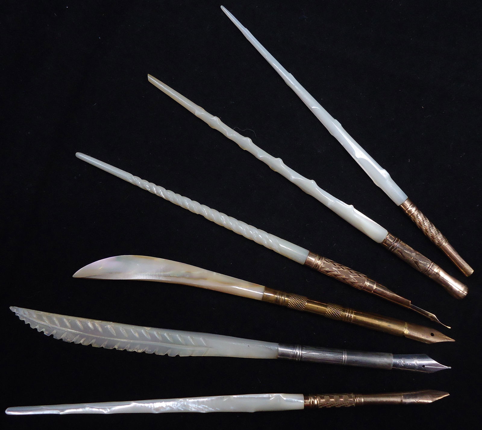 (6) CARVED MOTHER OF PEARL DIP PENS: (1) curved blade form shaft, textured grip; (1) spiral shaft, herringbone ferrule, Wing-flow 1 nib; (1) feather form shaft, ferrule marked Sterling E, Signature 6 nib; (3) with rustic "knob" type staf