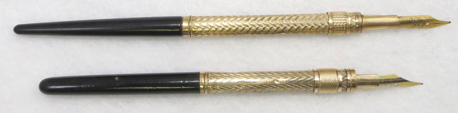 (2) EBONY SLIDE DIP PENS: (1) Morgan 14 Indestructible nib; (1) Hicks Pat. Sept. 13, 1864 with Curvex 14K gold plated nib; grip has two minor dents; longest L-6 1/4", G-VG