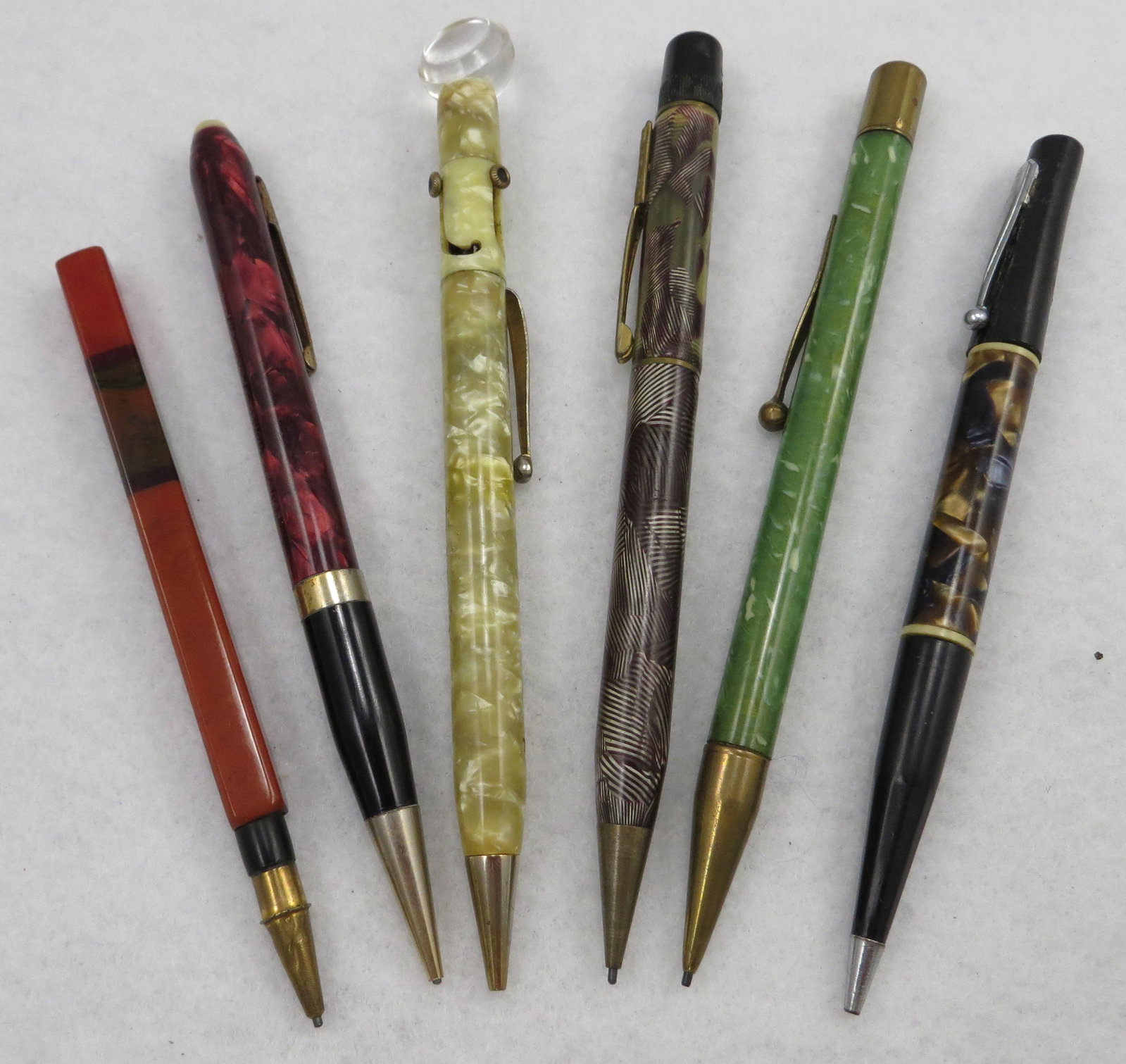 (6) MARBELIZED MECHANICAL PENCILS: Includes: (1) unnamed mechanical pencil, marbelized and patterned plastic , monogrammed HEH; (1) Tri-Point pencil, three colors lead with magnifyer top; (1) marbelized plastic mechanical pencil, with 