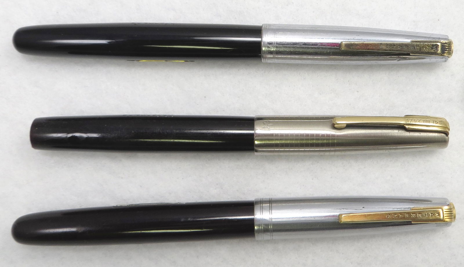 (3) VINTAGE WATERMAN FOUNTAIN PENS: All with chrome caps, black barrels; all three lever fill; (1) with significant end loss, Ideal 14K #17 nib; (1) very small unmarked nib; (1) Waterman's Emblem rigid nib; L-5", P-G+