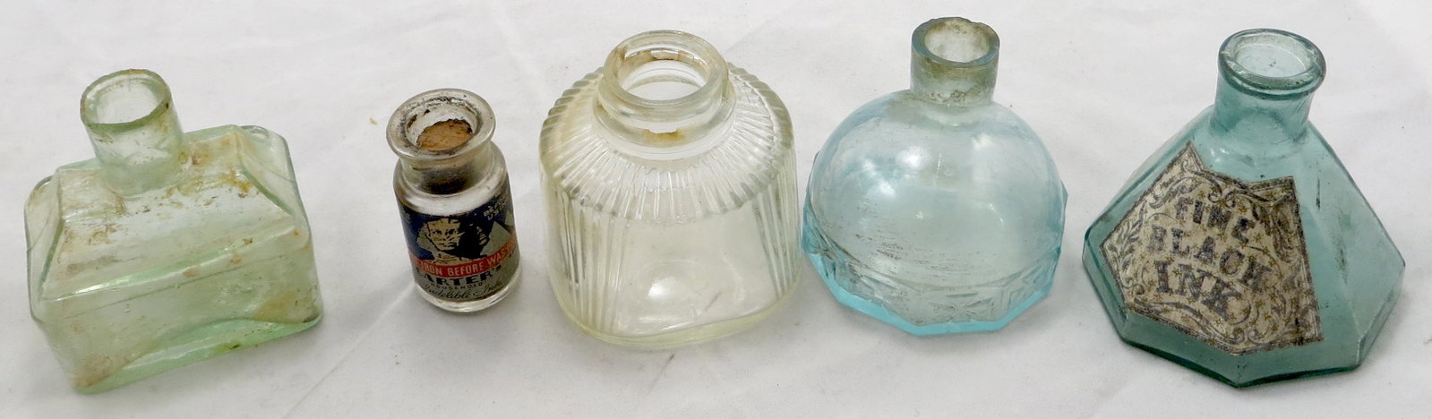 (5) ANTIQUE / VINTAGE INK BOTTLES: (1) igloo form bottle, light aqua glass, diamond pattern around base, roughness around rim; (1) house/cabin form bottle, roughness around rim; (1) "Parker" Anchor Hocking clear glass bottle, "Made in 