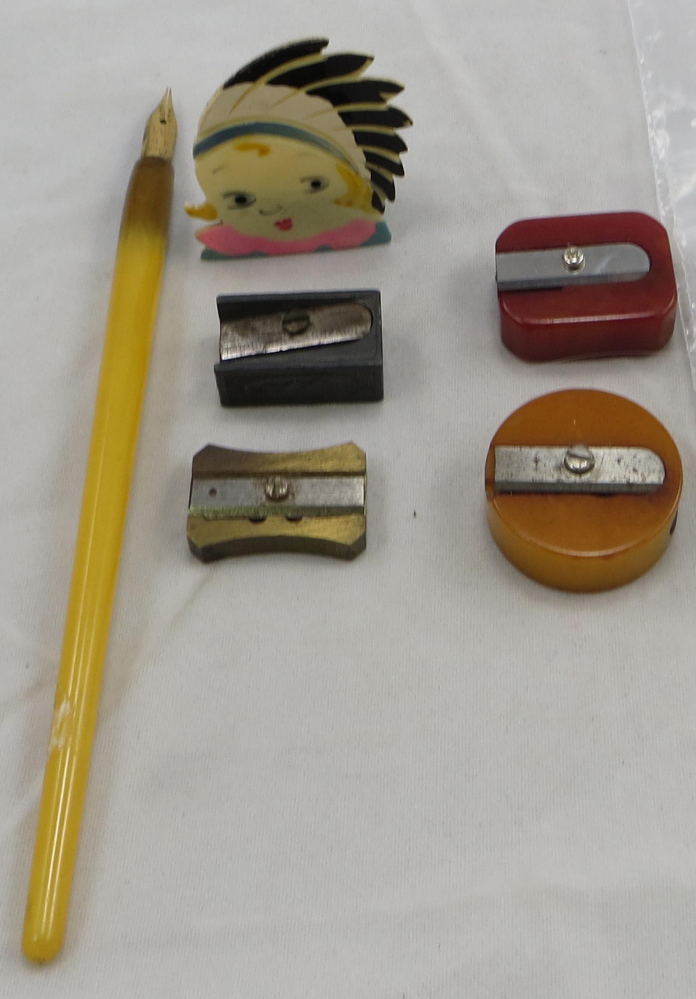 LOT OF (7) MOSTLY BAKELITE & PLASTIC PEN, PENCIL: Includes: (1) bakelite handle dip pen, Baff 14K gold nib; (1) red Bakelite sharpener, Cutwell; (1) round dark yellow sharpener; (1) celluloid/plastic Indian Princess sharpener; (1) brass "Minifix" Fab
