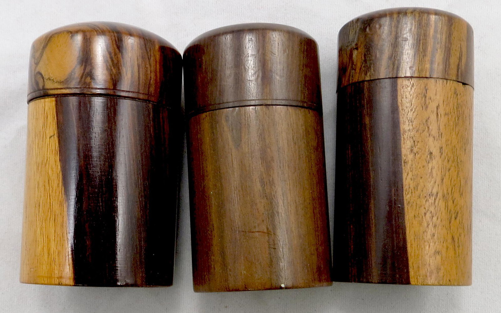 (3) TREEN TRAVELLER'S INKWELLS: Civil war era, circa 1860's, (2) turned wood, likely rosewood, (1) turned walnut, purported to be Silliman & Co.; each with screw cap and glass bottle interior; (1) with slight flattening to sides of 