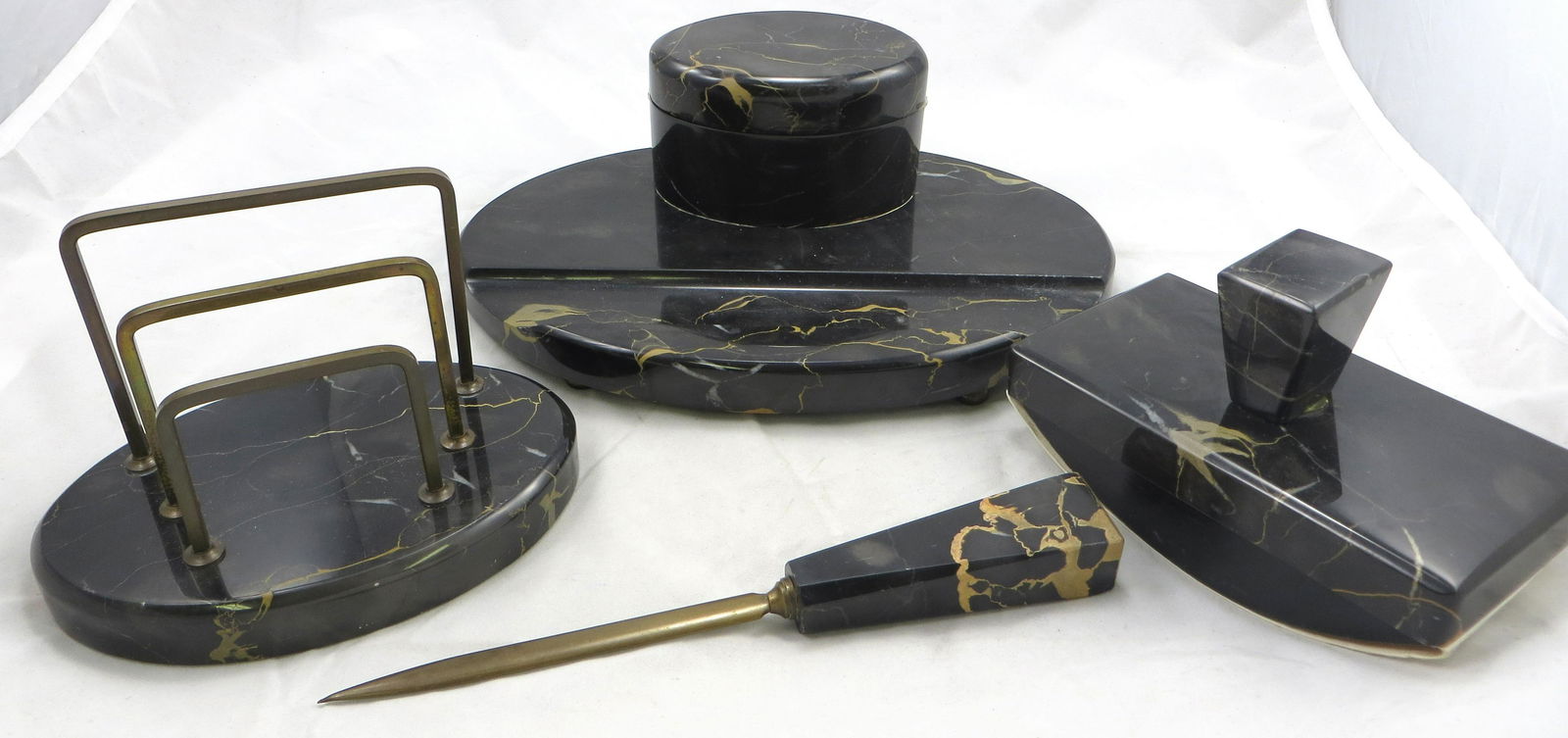 ART DECO BLACK MARBLE DESK SET: (4) pieces; inkwell with pen tray; glass insert; includes blotter, letter holder, letter opener; minor scuffs; longest L-9 1/2", VG-EX