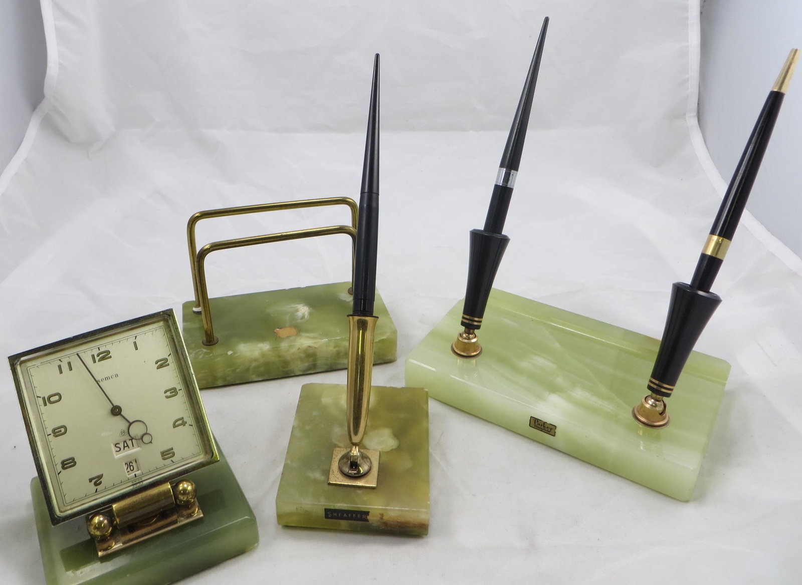 (4) GREEN ONYX DESK PIECES: (1) Parker Duofold double pen; (1) Sheaffer single pen; (1) letter holder; (1) "Semca" Swiss clock; some minor edge chips; (3) pens included; L-6", G-VG