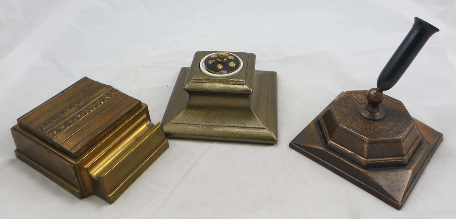(3) VINTAGE METAL DESK ACCESSORIES: Includes: (1) Vintage, Art Deco style inkwell: brass toned, integral pen holder; white porcelain insert; some edge dings; L-4"; (1) metal copper finish pen holder: square base; unmarked; L-3 1/2"; (1)