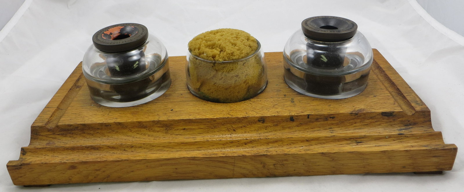 BUOY INKSTAND: Defiance Mfg. Co. NY, USA; Pat. No. 821852; oak base with double wells and sponge; bakelite funnels and floats; wood has some staining and minor split; normal wear overall; L-13 1/2", G-VG