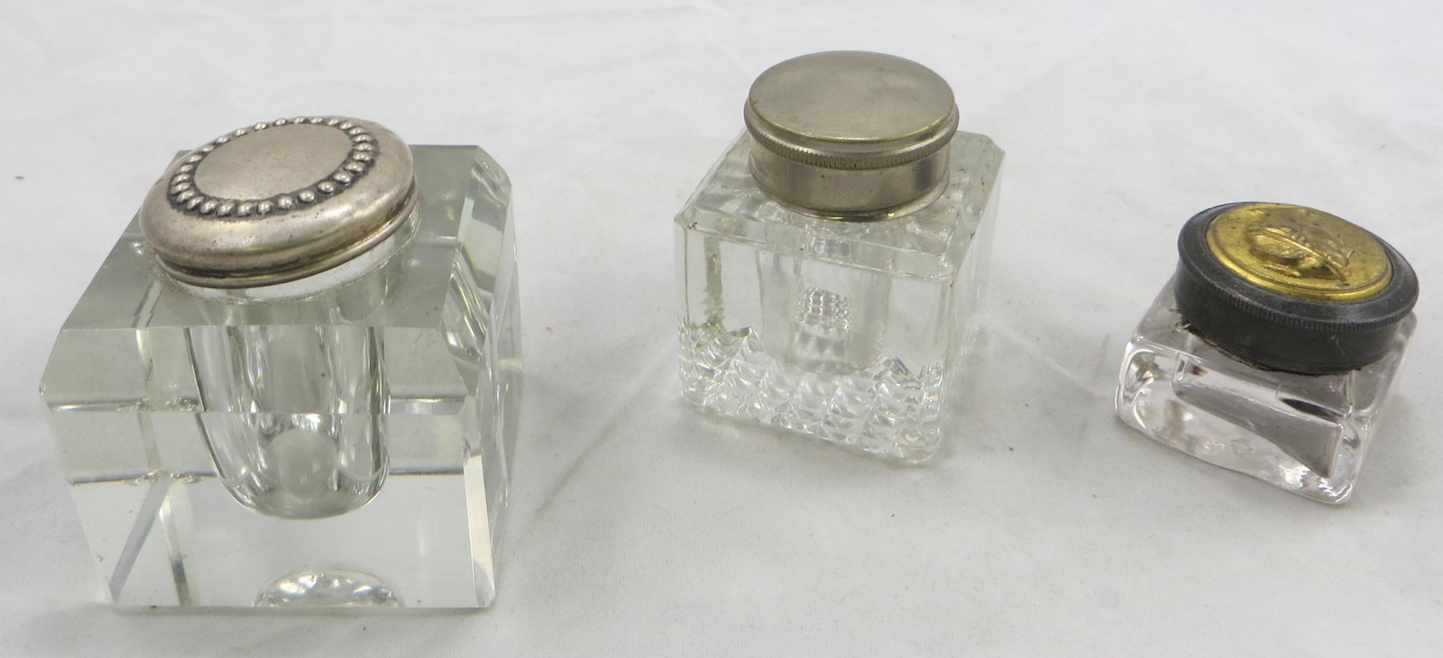 (3) INKWELLS: (1) travel inkwell: for lapdesk, screw-on lid with relief head; (1) sterling lid; (1) white metal cap; minor flaws; tallest H-2", G-VG