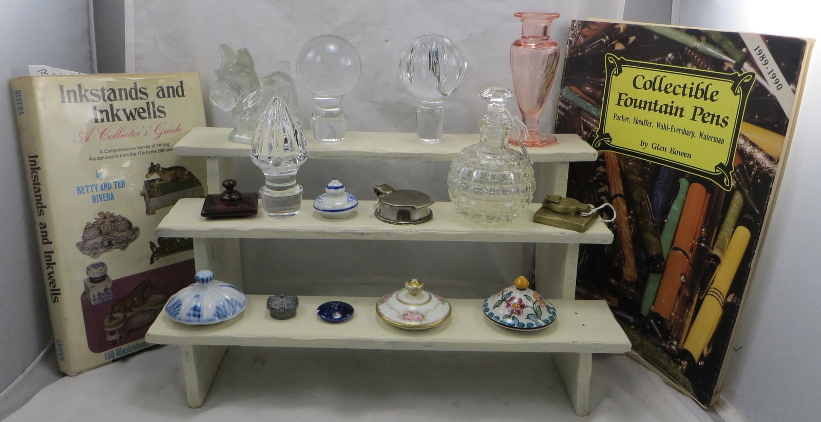 PENS, LIDS, BOOKS, PERFUMES, and MORE: (40+/-) pieces - including: (2) nib pens with 14K nib (swan mising lid and Harris); (30+/-) inkwell lids and bottle stoppeers; (2) perfumes, (1) stopper not original); (1) glass scottie dog candy cont