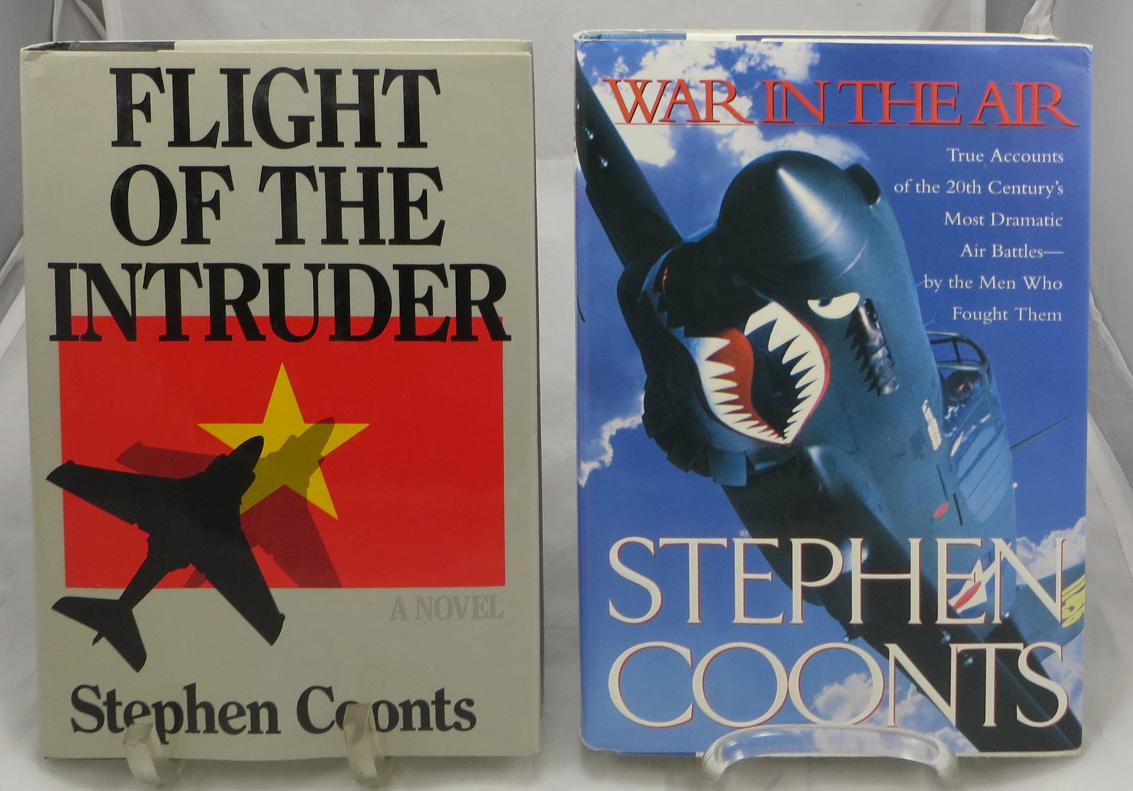 (2) SIGNED STEPHEN COONTS AVIATION THEME BOOKS: (1) Coonts, Stephen; "Flight of the Intruder"; Annapolis, Maryland; Naval Institute Press; 1986; signed on promo page; [329 pgs]; retains dustjacket; fictional novel about A-6 Intruder pilots in the V