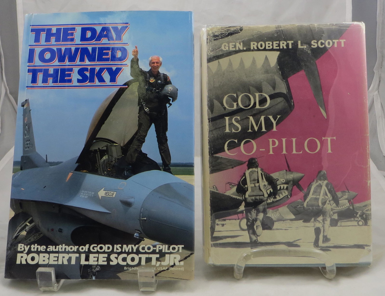 (2) WW2 AVIATION BOOKS ROBERT L SCOTT, SIGNED: (1) Scott, Jr., Robert L. (Gen.); "God is My Co-Pilot"; New York, Ballentine Books; 1943, possibly first edition; retains dust jacket; signed and dedicated on title page "To Sarah Anne & John Elliot -