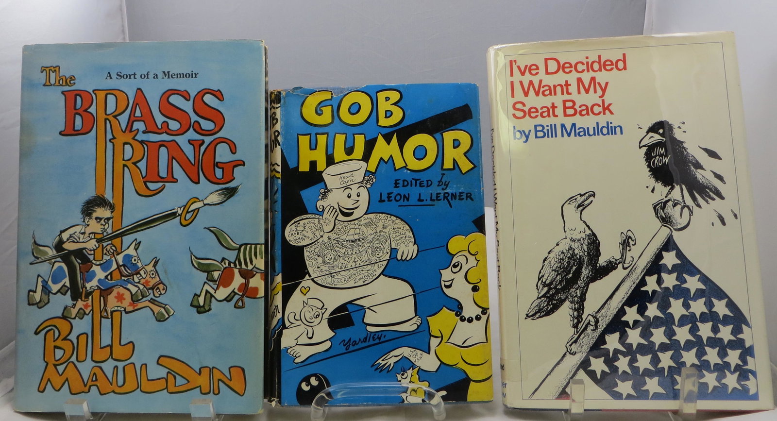 (2) WWII ERA HUMOR BOOKS - MAULDIN, etc.: (1) Lerner, Leon L; (1) " Gob Humor"; L & M Ottenheimer, Publishers; Baltimore, MD; 1953, first edition; retains dust jacket; [183 pgs]; dust jacket is clipped; some toning to pages; edge tears and lo