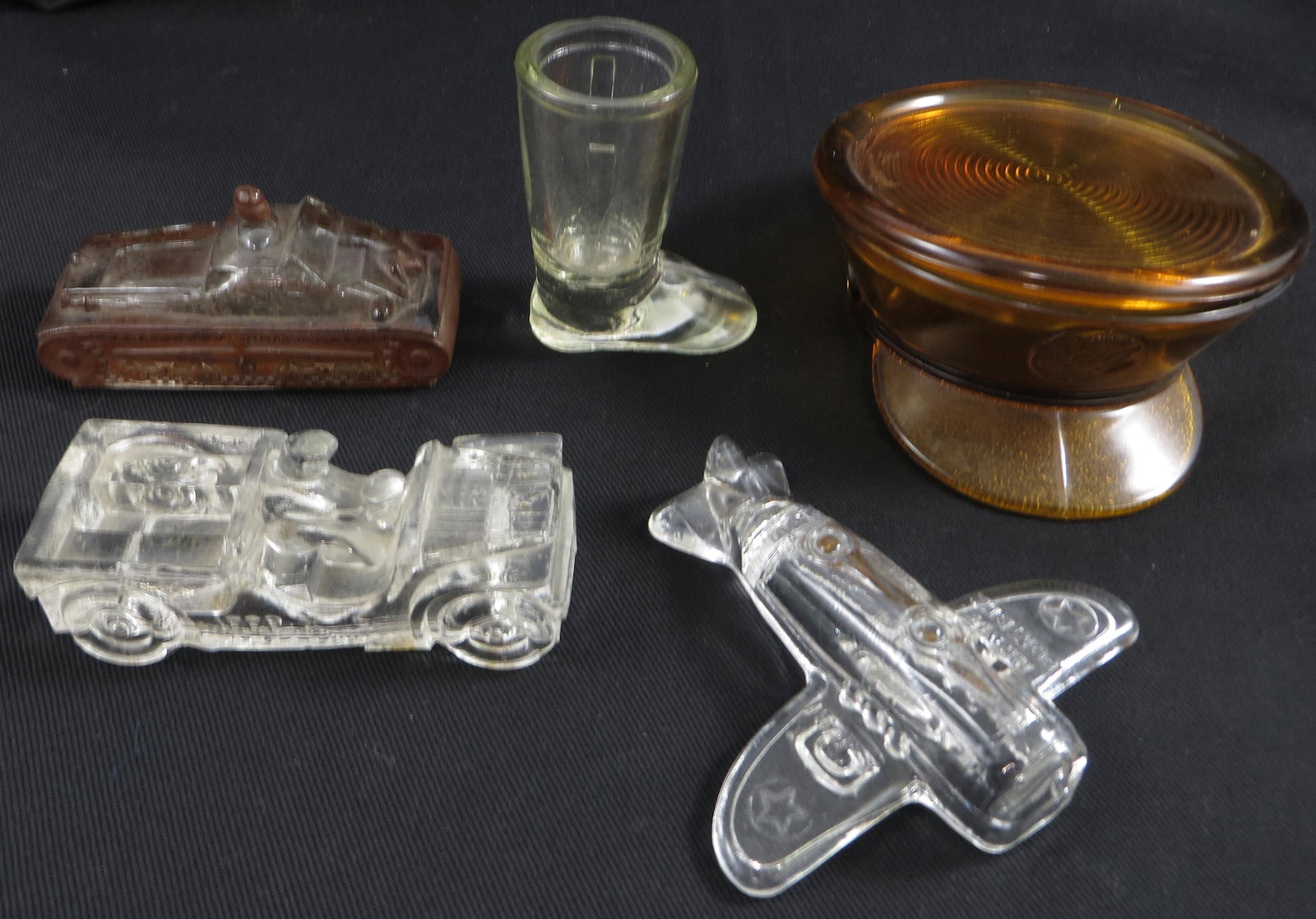 (5) VINTAGE GLASS CANDY CONTAINERS / DISHES: Includes: Army bomber, jeep, boot, Victory glass tank, amber military hat; tank has minor paint loss; longest L-6", VG-EX