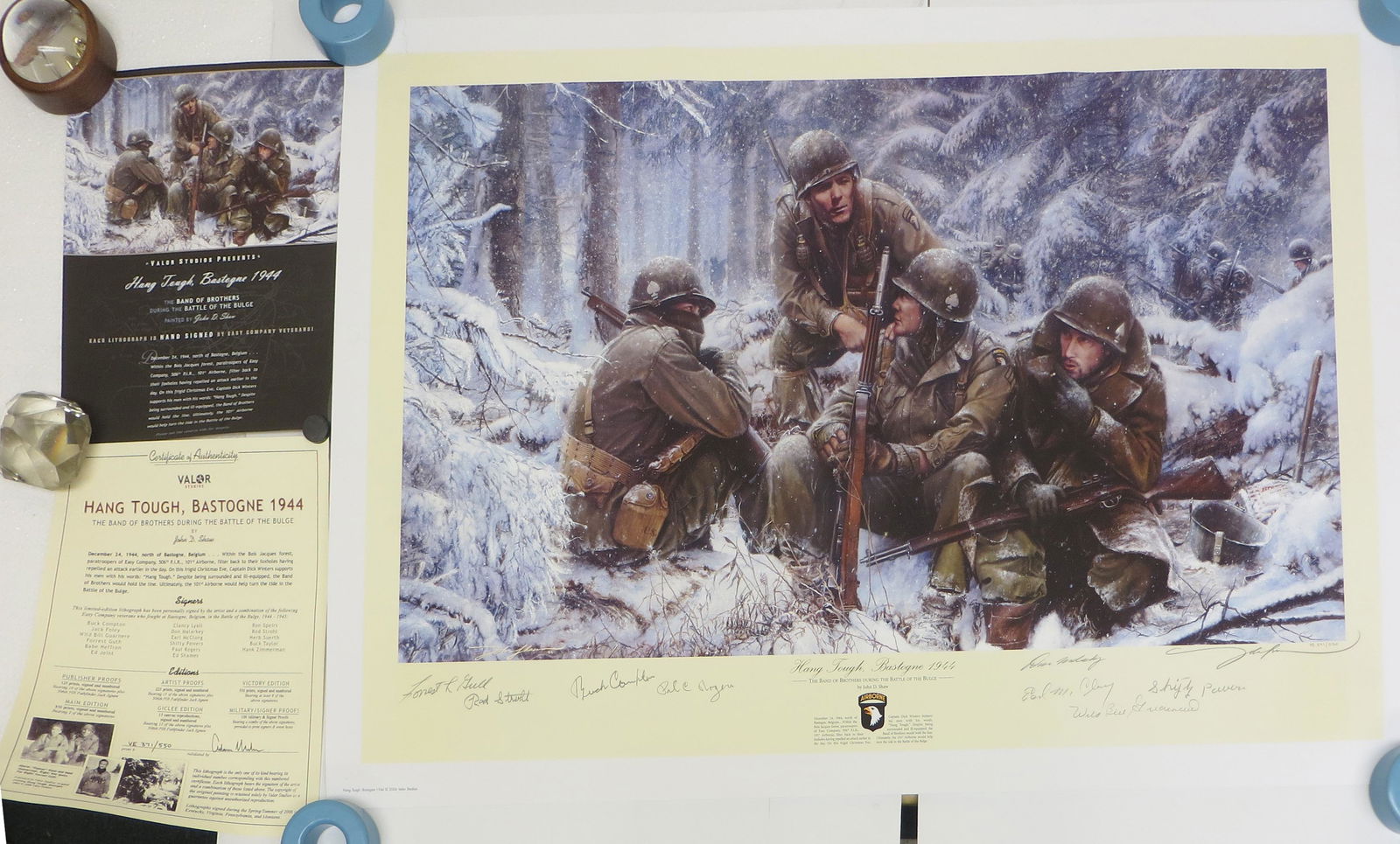 WWII JOHN SHAW PRINT - SIGNED, HANG TOUGH BASTOGNE: Artist signed, limited edition, 371/550; "Hang Tough, Bastogne 1944"; the Band of Brothers during the Battle of the Bulge, retains letter of authentiticity; signed by (8) Veterans who fought in the Ba
