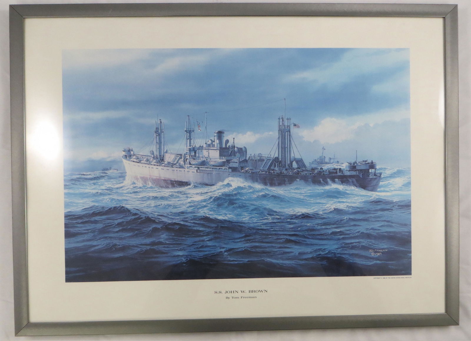 (2) WWII JOHN W BROWN PRINTS: (1) "The Liberty Ship" by John Stobart, artist signed and numbered 161/750; image 23" x 33"; (1) "SS John W. Brown" by Tom Freeman, image 17" x 23", VG-EX
