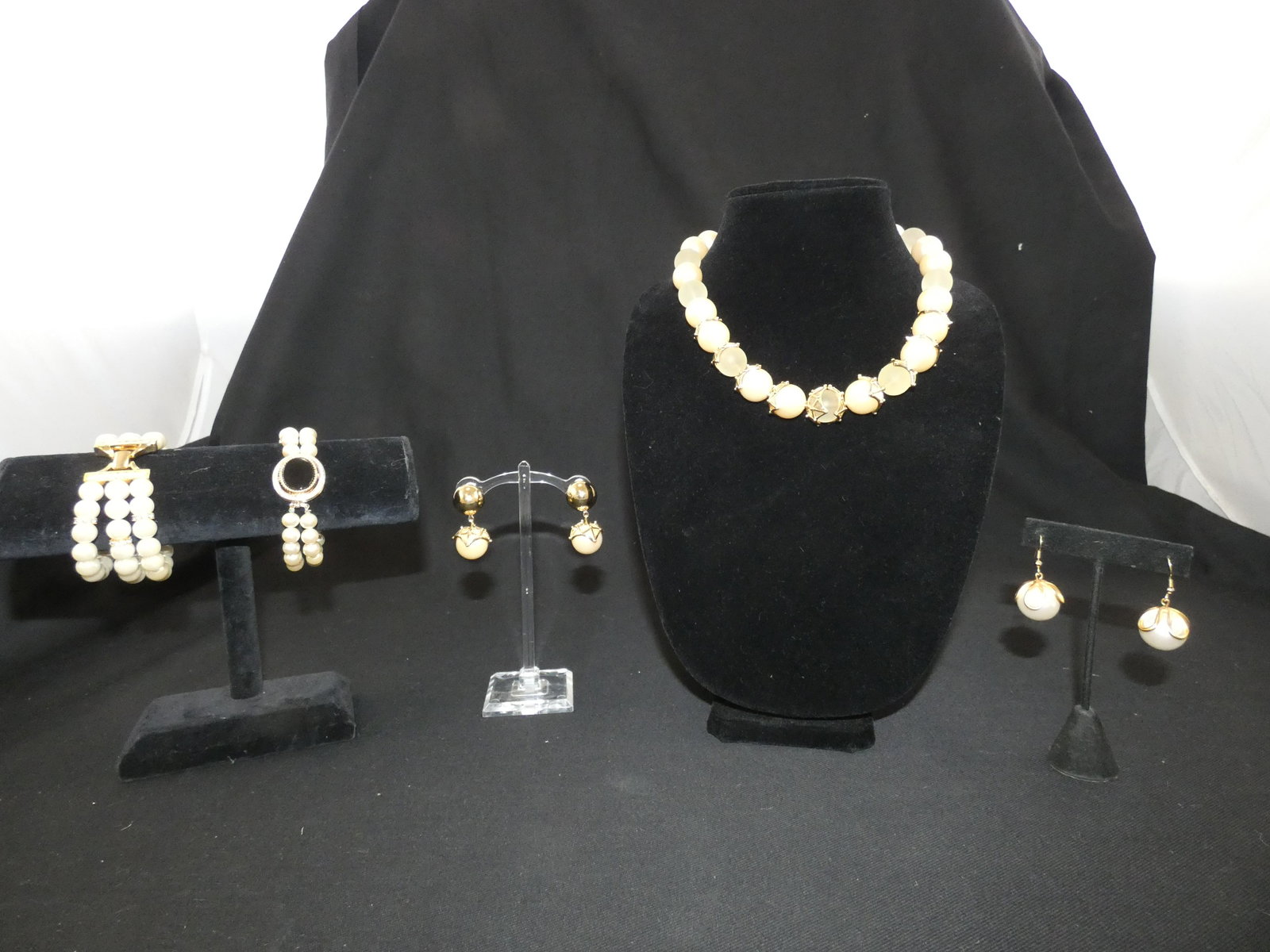 GIVENCHY, ETC. COSTUME PEARL JEWELRY (5): Simulated pearls; (1) Givenchy necklace / clip earrings set, retains Neiman Marcus store tags; (1) pair dangle pierced earrings; (1) 2-strand "Sky" bracelet with black clasp; (1) 3-strand bracelet wit