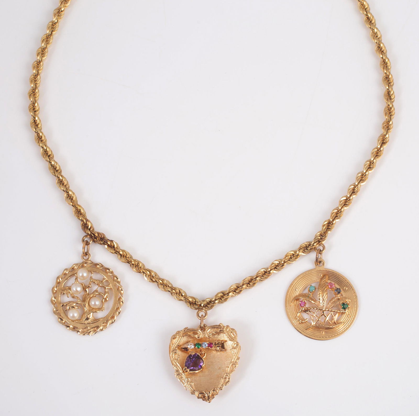 14K GOLD CHARM NECKLACE with (3) CHARMS: Rope necklace, charms are soldered onto the necklace; (1) charm: heart shape with heart amethyst 6 x 4 mm, (1) cubic zirconia, (1) synthetic emerald, (1) synthetic aquamarine, (1) synthetic ruby; (1)