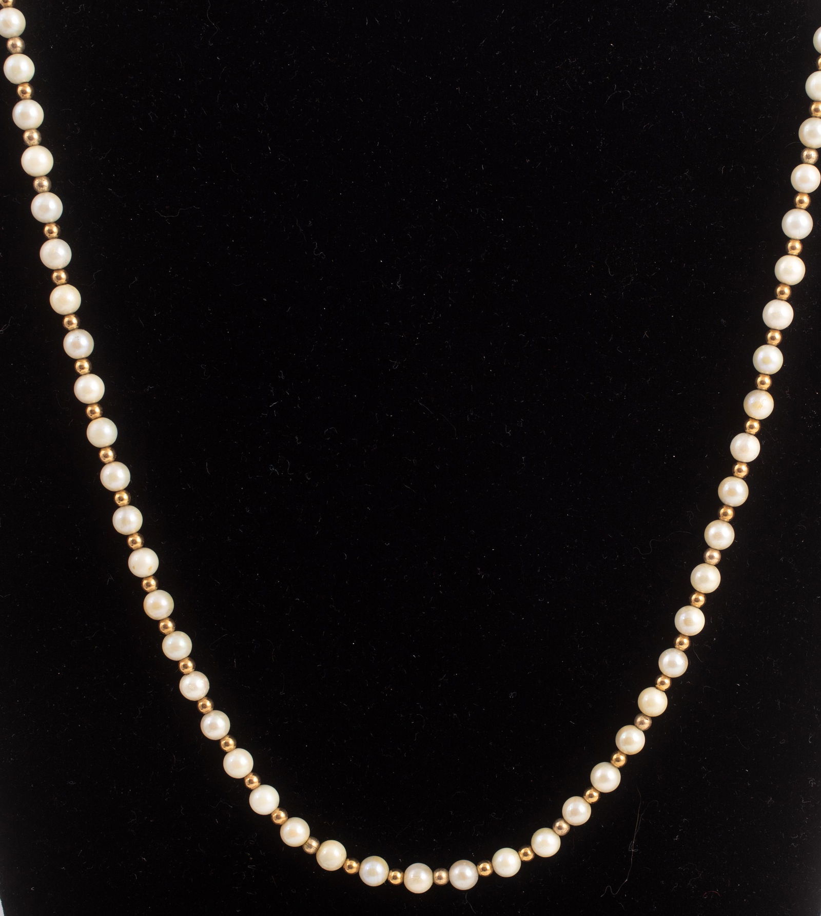 PEARL AND GOLD BEAD NECKLACE: single strand of pearls, (78) 5 mm pearls, alternating with 3 mm yellow gold pead; maple leaf clasp with (9) 3mm half drilled pearls; 25" long; unmarked