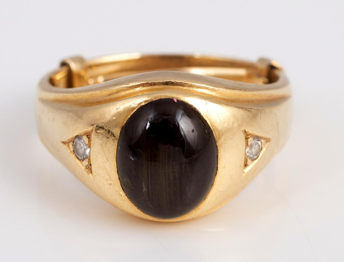 14K BLACK STAR SAPPHIRE MAN'S RING: 14K Yellow gold ring, set with 11 x 9 mm oval natural black star sapphire and (2) .01 carat full cut diamonds; total weight 10.8 grams; size 9.5