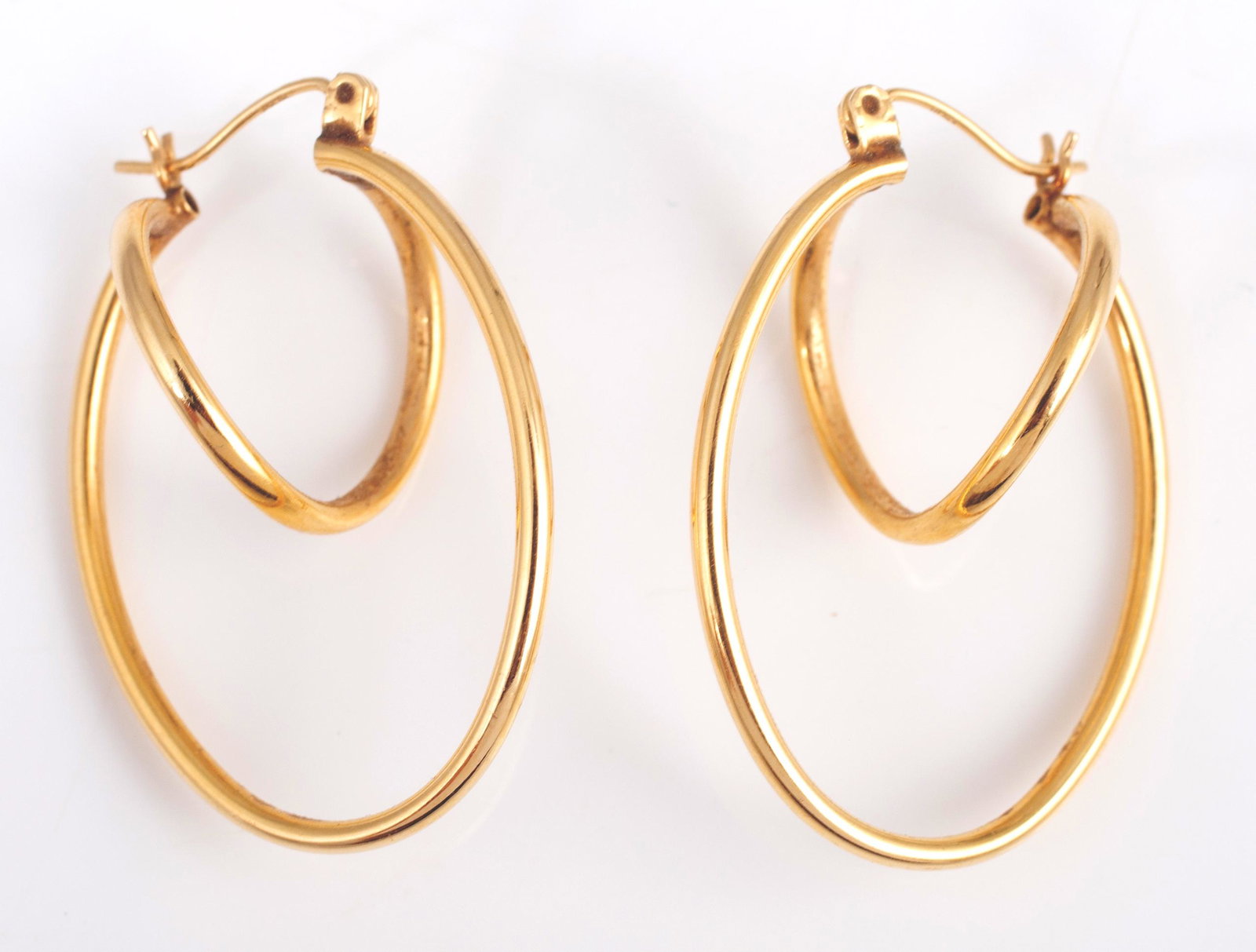 PAIR OF YELLOW GOLD DOUBLE HOOP EARRINGS: Twisted hoop-within-a-hoop design; bar closure; L-1 3/8", 2.9 grams