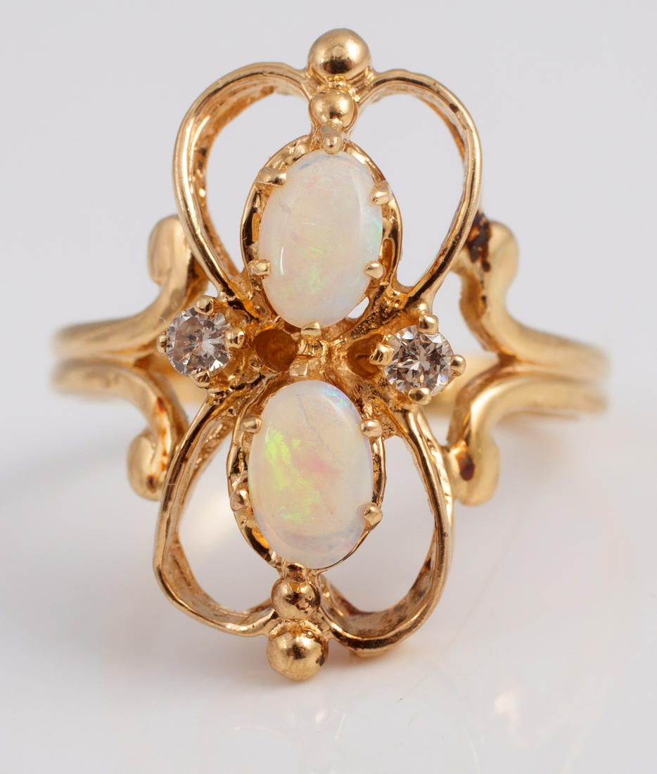 14K OPAL & DIAMOND RING: Double loop form, two oval opals approx 4mm x 6mm, stacked; with (2) approx. .04 carat diamonds on either side; ring size 7; total weight 3.87 grams