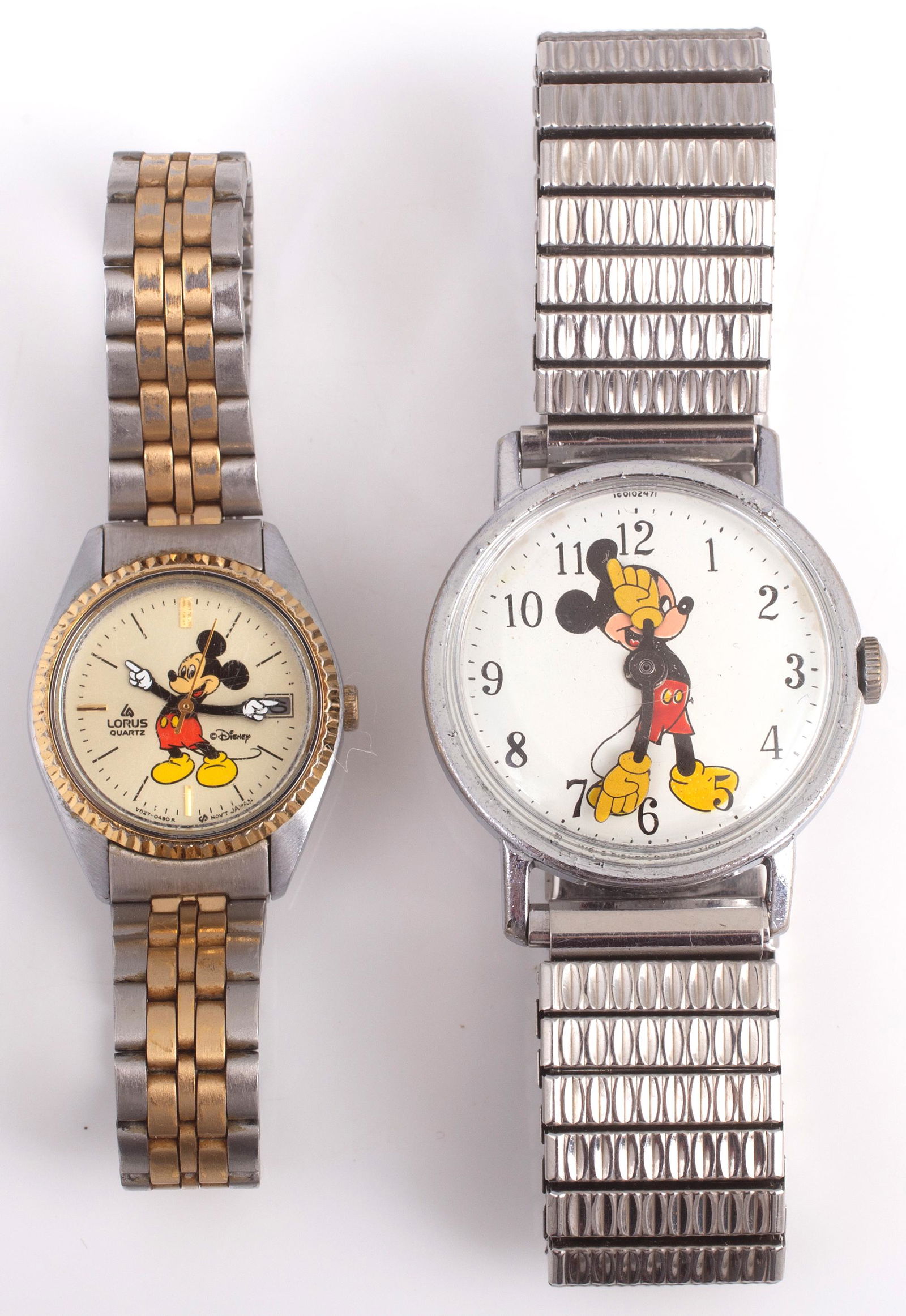 (2) MICKEY MOUSE QUARTZ WATCHES: (1) ladies' Lorus watch, 2-tone stainles steel band; (1) man's Mickey Mouse watch, Walt Disney Productions; stainless steel expandable band; some flaking to plating on bezel, both untested; overall G-