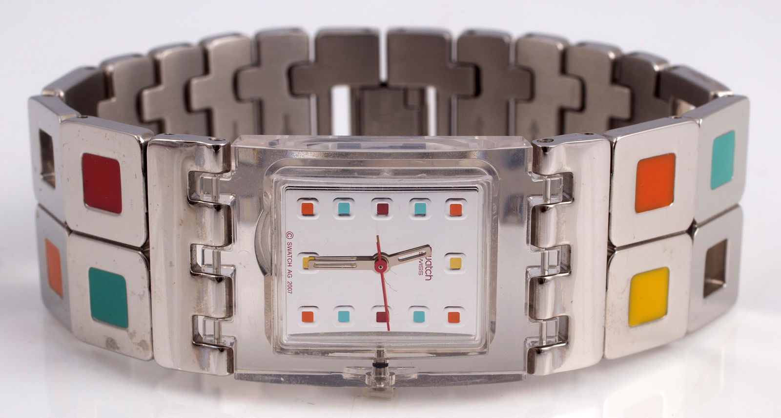 STAINLESS SWATCH WATCH with ORIGINAL BOX: Retains original paperwork and guarantee; lucite bezel with stainless color-block band; appears never worn; original clear plastic box has break / loss at latch; L-7 3/4"; 25 mm wide