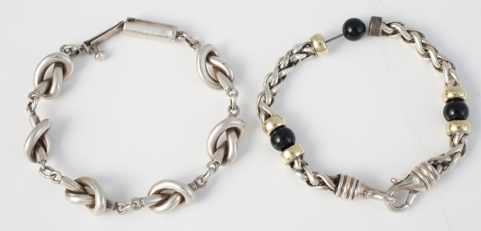 (2) STERLING BRACELETS: (1) knot form bracelet, barrel style clasp, stamped (illegibly) TS-SN Mexico 925; L-8"; (1) unusual form bracelet, double link interspaced with goldtone collars and black beads; lobster clasp; broken: