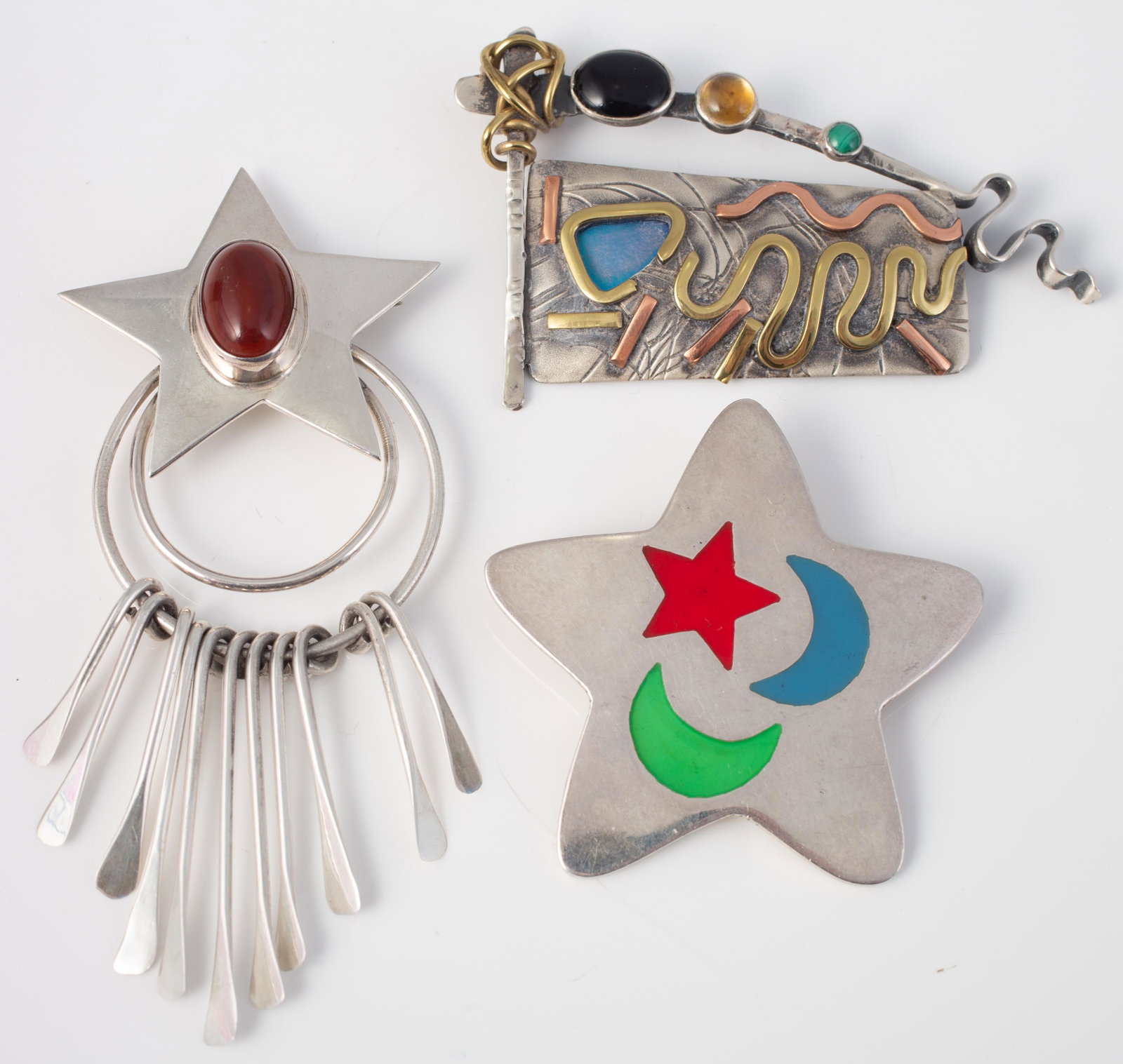 (3) STERLING & SILVER BROOCHES: (1) Star and ring pin, set with red cabochon stone, marked "Mexico I-HI 925", L-3 1/2"; star-form pin/pendant, marked Mexico 925 TG-205, enameled star and moon pattern; L-1 7/8"; (1) artist made mixed