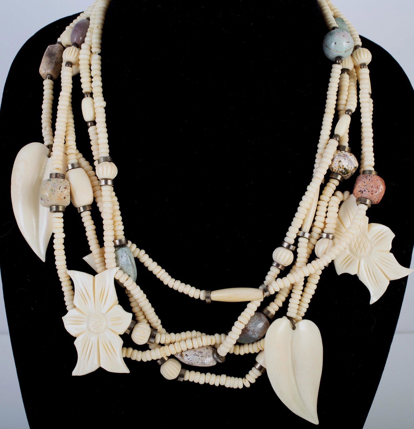 LES BERNARD 5-STRAND NECKLACE: Plastic beads made to look like carved bone, stone beads, etc.; signed clasp; L-22"