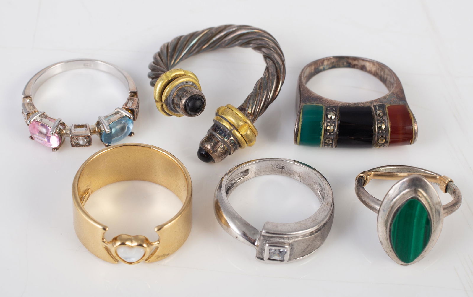 (6) STERLING RINGS: Includes: (1) set with marcasite, malachite, onyx, etc.; (1) with gold wash; Israel; (1) sterling band with clear stone; (1) set with malachite; (1) set with pink and blue stones; (1) heavy wrap style