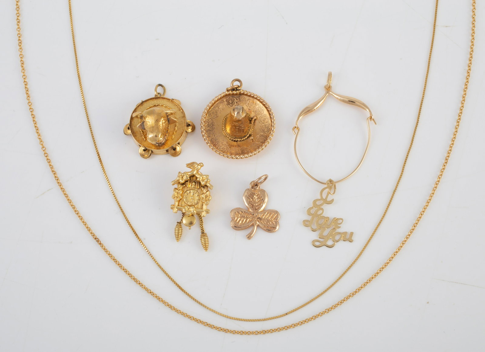 ASSORTED GOLD NECKLACES, CHARMS, ETC. (8): (1) 17 1/2"" 14K fine box link chain; (1) 17 3/4" 14K open link chain; (1) 14K sombrero charm, (1) 14K charm holder (somewhat misshapen); (1) 14K "I Love You" charm; (1)9k shamrock charm,1.05 g (1) 8k