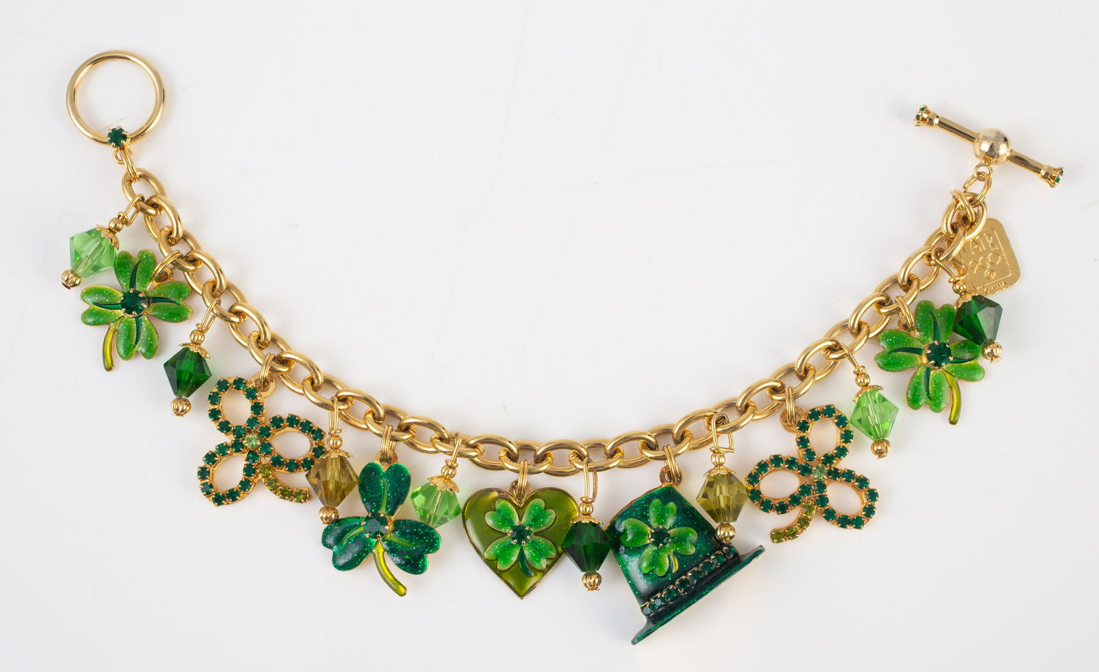 LATR 2GO LUNCH AT THE RITZ ST. PATRICKS BRACELET: Goldtone charm-style bracelet with numerous enameled, beaded, and rhinestone charms; includeing shamrocks, hats, etc.; toggle clasp, retains original tag; L-7 3/4", EX