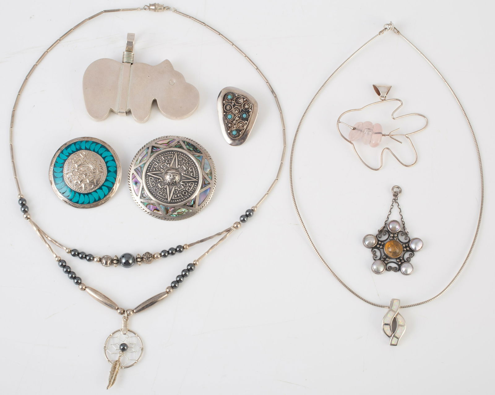 (8) PCS. STERLING & SILVER JEWELRY: (1) silver choker necklace with dream catcher pendant; (1) pendant with pearl and amber cabochon stones; (3) sterling pendant/pins, 1-Aztec design, 1-turquoise beads, 1-Aztec calendar with abalone bor