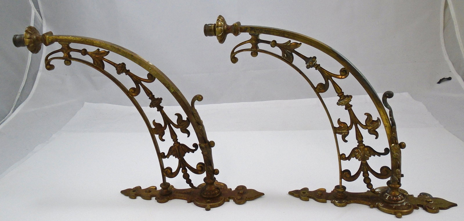 PAIR OF ORNATE VICTORIAN LIGHT SCONCES: Likely gilded bronze; floral and scroll form; no wiring; marked Rd 26950; missing (1) ball-form nut; some metal polish residue; some metal discoloration, etc.; total length 15", projection from wall: 