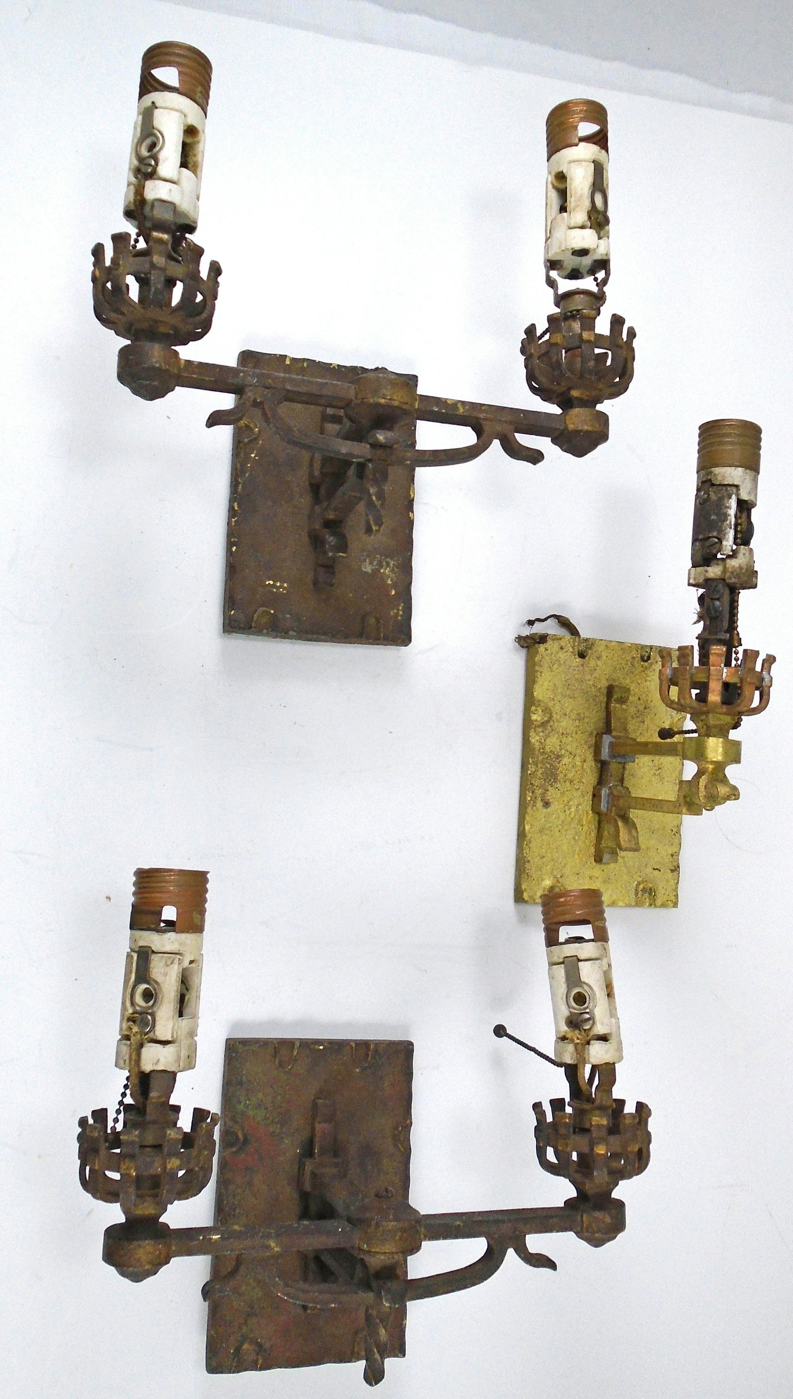 SET OF (3) ARTS & CRAFTS WALL SCONCES: Electrified candle-style sconces, (1) pair of two arm sconces, (1) single sconce; single has been polished or similar to reveal brass construction; both double sconces have dark age patina, paint resi