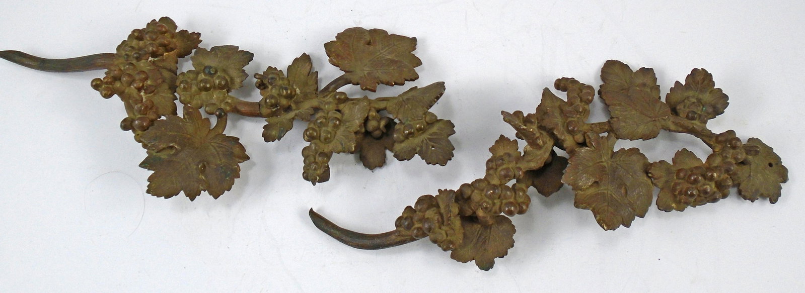 (2) BRONZE ARCHITECTURAL GRAPE DECORATIVE ELEMENTS: Pair of patinated bronze decorative elements, each with a single mounting hole; grape vine and grape motif; (1) has a small weakness in the center of the "vine", still attached, but could use glue/sup
