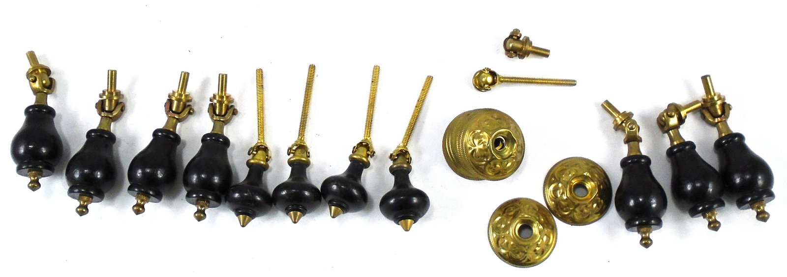 SELECTION OF BRASS & WOOD VICTORIAN DROP PULLS: Turned wood drops, painted black; with stamped brass round bezel surrounds; (7) matching, with bulbous form and heavy brass hinges; (4) matching with "onion" form and threaded screws; (1) additional b