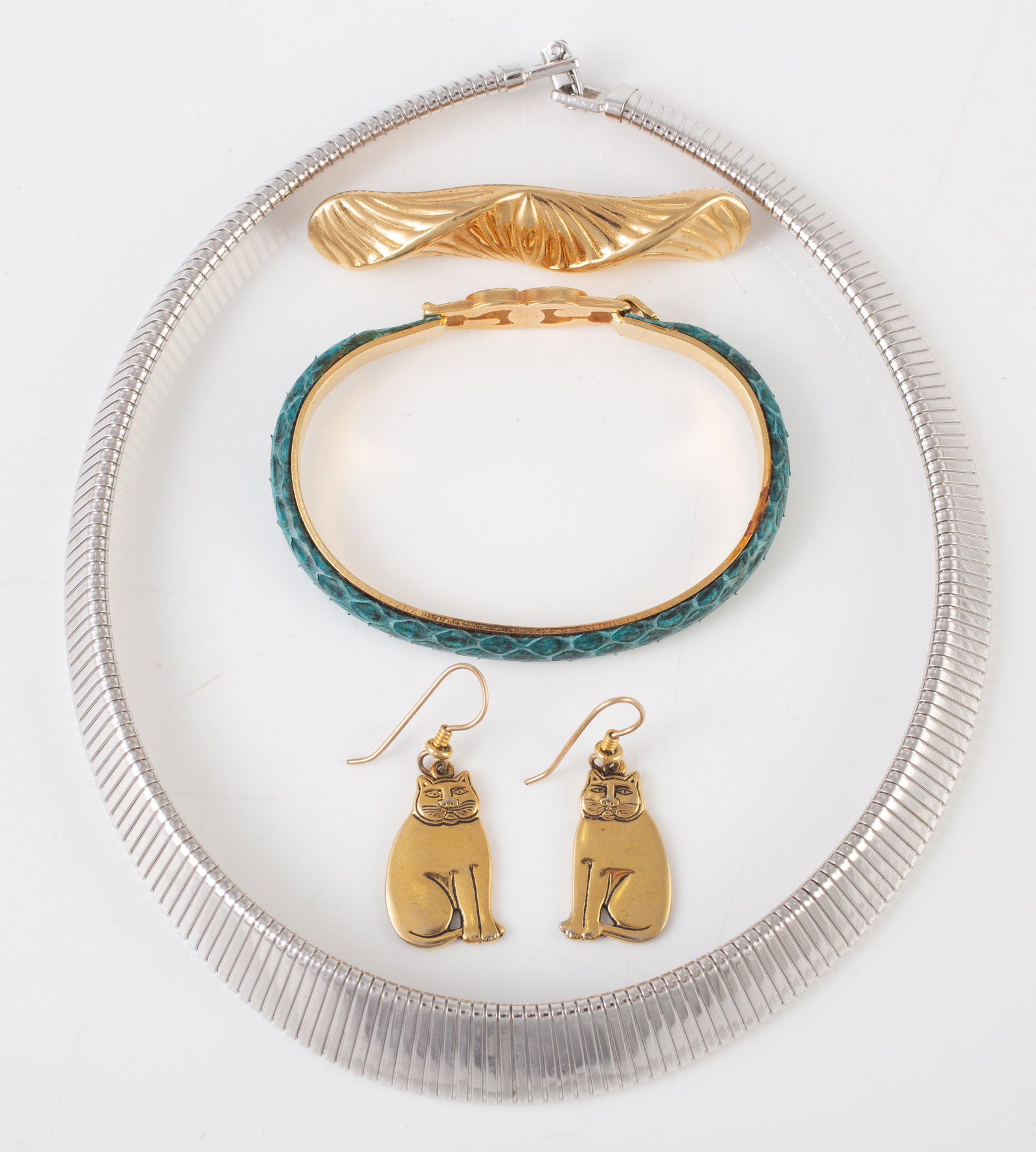 (4) PIECES DESIGNER, ETC. JEWELRY: (1) Monet silvertone necklace; (1) Monet goldtone bar pin; (1) Laurel Burch cat earrings, goldtone, signed; (1) goldtone and leather "Made in Italy" bracelet; largest 16", VG