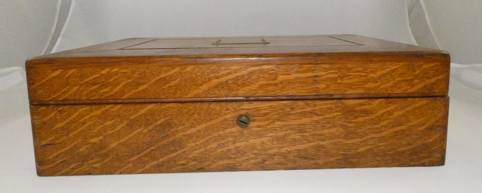 QUARTERSAWN OAK ARMIGER SILVER CHEST: oak chest with heavy brass handles, brass inscription plate on top (blank); red silver cloth interior, gold stamped Armiger Bros. Baltimore; fitted interior with lift-out tray; no key; some surface sc