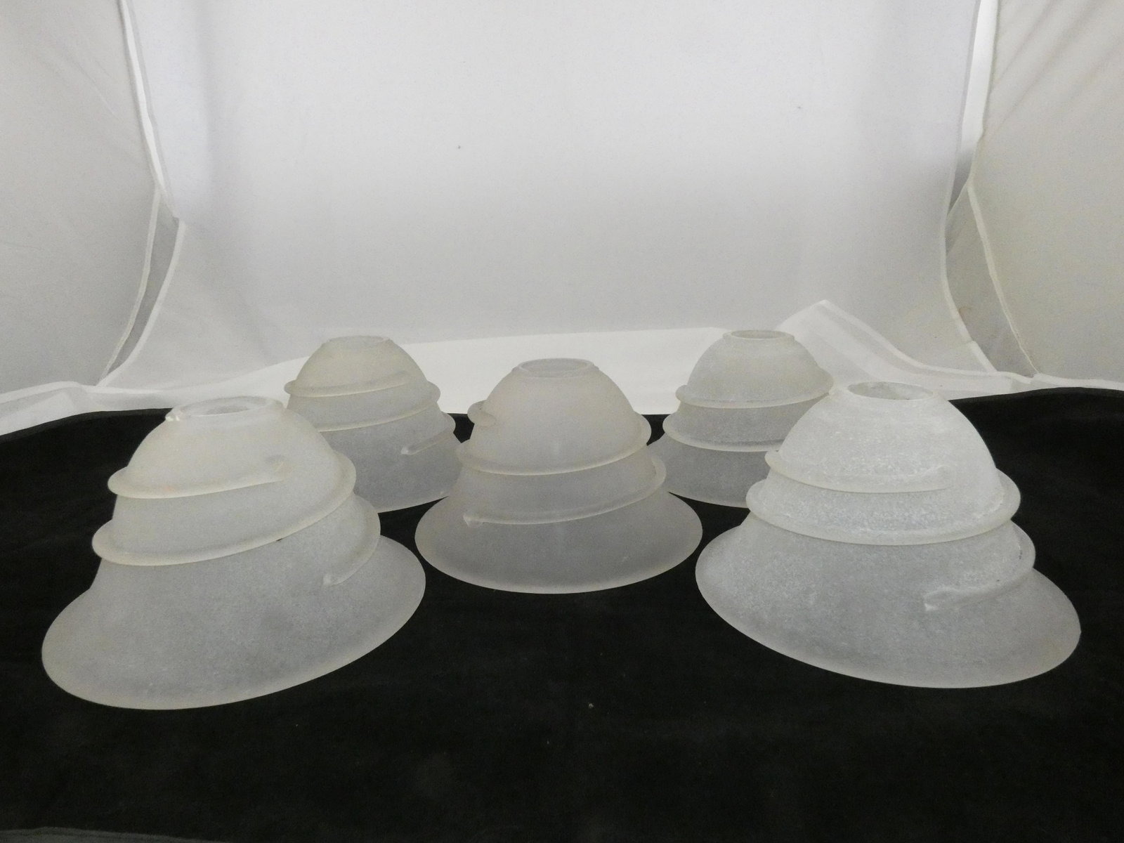 (3) FROSTED GLASS SHADES: Frosted glass shades with applied glass "swirl", 1 1/8" at socket; diameter-8", height-5"; together with two additional shades with significant losses to "swirl"; some minor chips around socket area; 