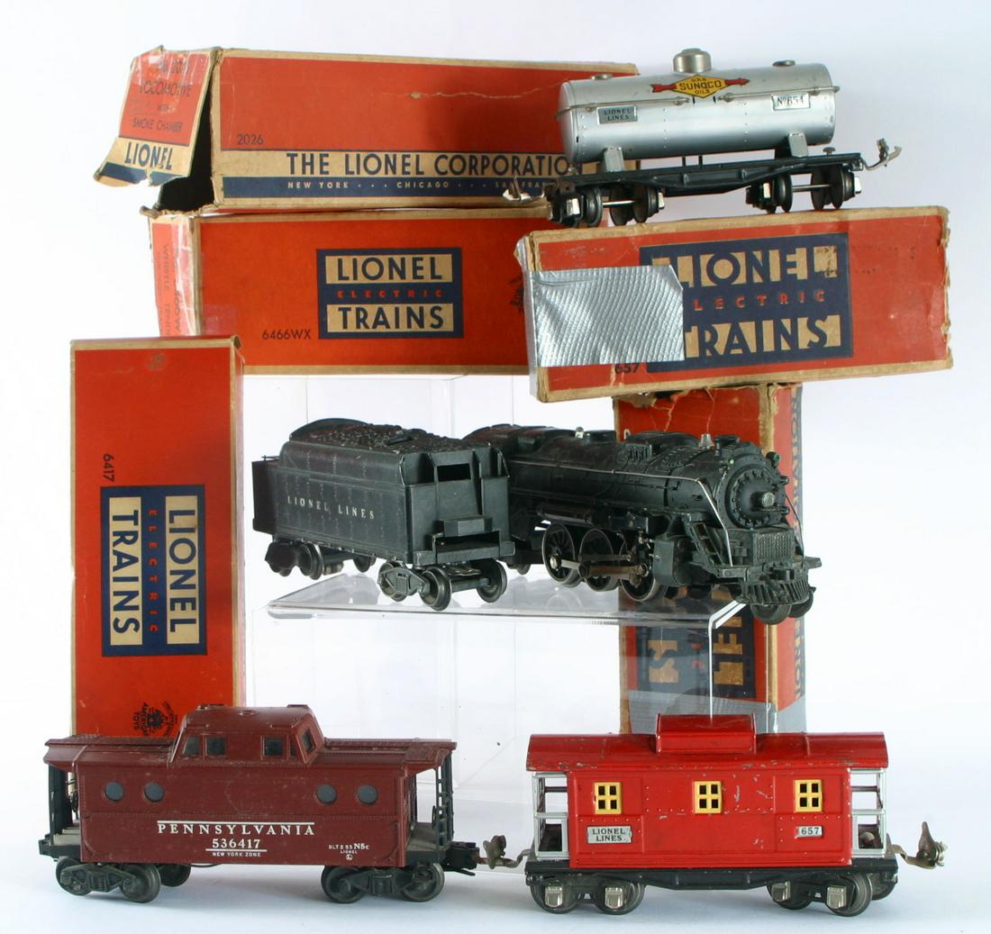 LIONEL ENGINE, TENDER & CARS (5): Original boxes; metal, tin litho and plastic construction; O gauge; (1) 2026 locomotive with smoke chamber; (1) 6466WX Whistle Tender for "O27" track; (1) 657 metal caboose; (1) 6417 plastic body cabo